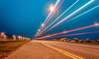 Long Quiet Road with Streaks of Car Lights at Night under Blue Hour Sky, Hong Kong