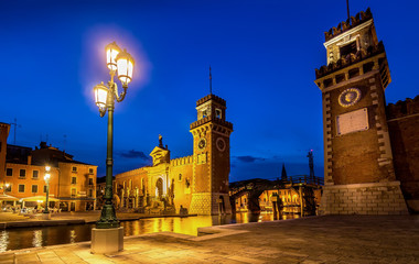Venetian Arsenal at Dusk under Blue Hour Sky and Vibrant Street Lights in Venice, Italy