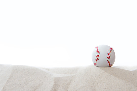 Baseball in the sand on white background . Team sport concept