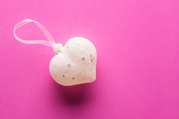 Sugar heart on a pink paper background