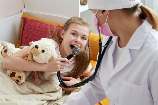 Girl Having Fun With Doctor And Her Stethoscope At Home