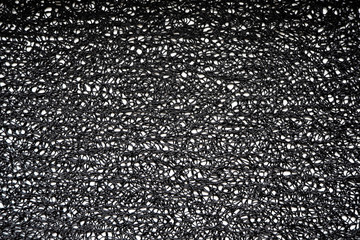 black and white background . texture of intertwined silicone threads on a white background. black decorative Mat