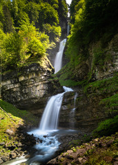 Fototapeta na wymiar view of the idyllic Diesbach creek waterfall in the Swiss Alps near Braunwald and Glarus in the spring