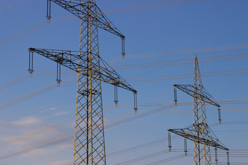 High voltage poles against the sky