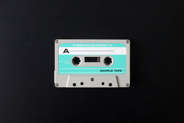 Fototapeta premium Old tape cassette, old or aged wood background. İsolated casette
