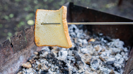 Cooking toasts on the grill. A piece of bread is fried on a grill 