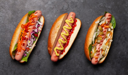 Various hot dog with vegetables, lettuce and condiments