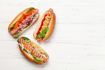 Various hot dog with vegetables, lettuce and condiments