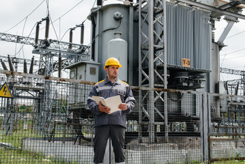 The energy engineer inspects the equipment of the substation. Power engineering. Industry