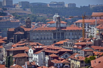 Fototapeta na wymiar Porto, Portugal - August 20, 2015: Cityscape of Porto, near the Douro river. Focus on the Palácio da Bolsa (Stock Exchange Palace) and the church Sao Francisco.