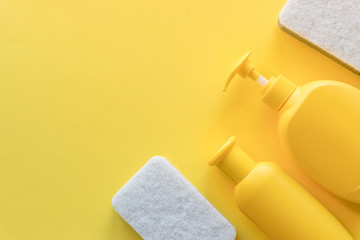 Cleaning service banner mockup. Flat lay house cleaning supplies on yellow background. Top view cleaner spray bottle, rag, sponge, detergent. House cleaning and housekeeping concept