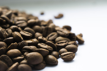 Coffee beans are poured from the mountain, macrophotography, one grain in focus, photo with transition