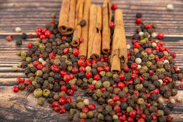 Cinnamon and spices in bulk lie on a dark wooden background.