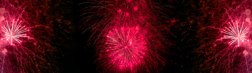 Red and white fireworks with smoke over the black sky. Low key exposure.