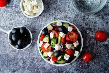 Greek Salad with ingredients in a white bowl