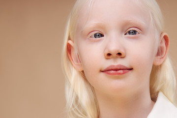 portrait of awesome albino kid with blonde hair. Fashion style and beauty look. Child with unusual...