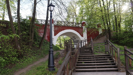 wooden stairs heading to park arch