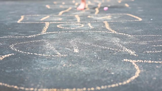 little girl playing hopscotch slow motion