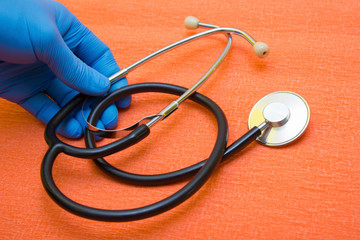 Hands medical gloves hold stethoscope - protection during quarantine, coronavirus, covid19