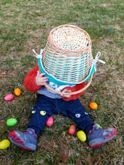 Toddler Places Basket on his Head During Easter Egg Hunt