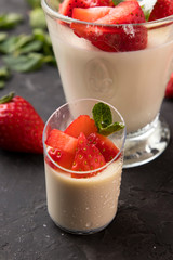 
Buffet menu in disposable utensils from a catering company. On a dark background