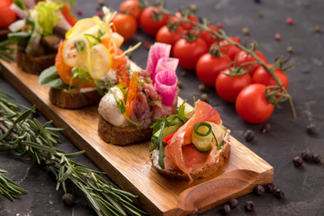 
Buffet menu in disposable utensils from a catering company. On a dark background