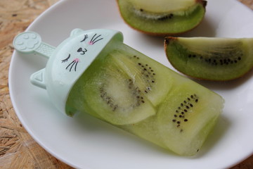 kiwi ice-cream. kiwi fruit on a wooden table. fruit ice-cream. mix ice-cream