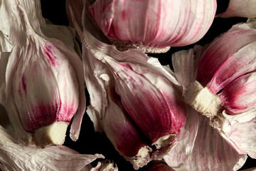 Fresh garlic close-up on a black background, spices, ingredients