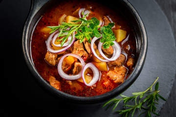 Traditional Hungarian goulash - stew of meat and vegetables with onions