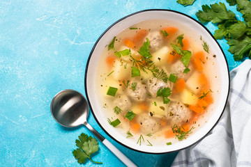Meatballs soup with vegetables top view.
