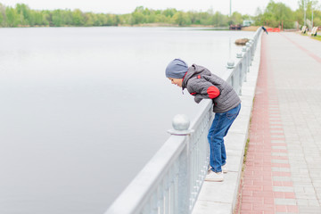  A little boy walks along the embankment
