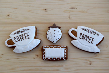  Gingerbreads in the form of cups with coffee, a napkin, a sugar bowl. Gingerbreads are on a wooden...