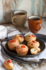 Muffins with cheese, cottage cheese and tomatoes, served with tea.