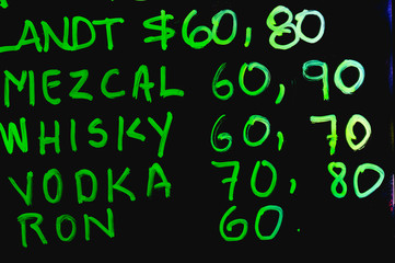 Mezcal, whisky, vodka, rum, Tijuana liquor price sign