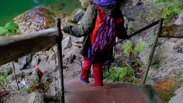 Women hiking together in mountainous landscape, going down stairs.