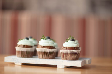 cupcakes with blueberries on the Board