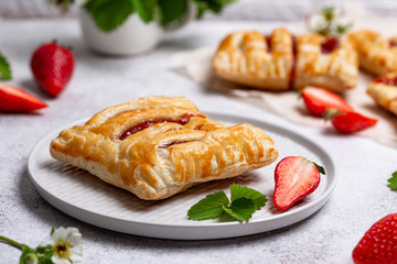 Sweet puff pastry cakes with strawberry
