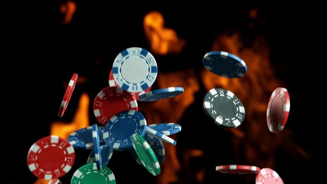 Poker chips falling on casino table in super slow motion, filmed on high speed cinema camera at 1000 fps. Gambling background.