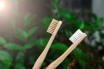 bamboo toothbrushes close-up on a background of nature. green bokeh. biodegradable materials....