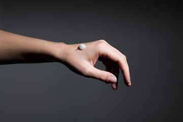 Hand of a woman applying cream