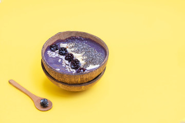 Healthy breakfast blackberry smoothie bowl with banana and seeds