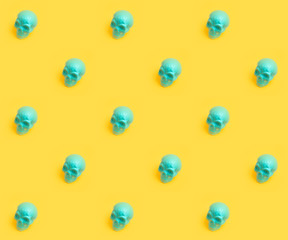 Blue traditional mexican skull pattern over yellow background