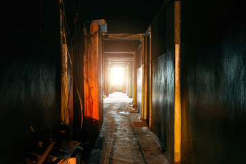 Burnt old house interior. Ruined coridor walls in black soot. Consequences of fire