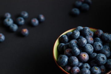 Blueberries in a bowl, on a dark table