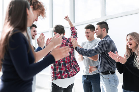 group of happy employees standing in the office.