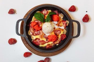 Baked banana and strawberries with ice cream. Fresh summer dessert