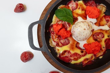 Baked banana and strawberries with ice cream. Fresh summer dessert