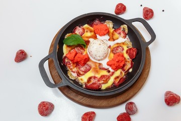 Baked banana and strawberries with ice cream. Fresh summer dessert