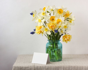 yellow and white daffodils and an empty white card.