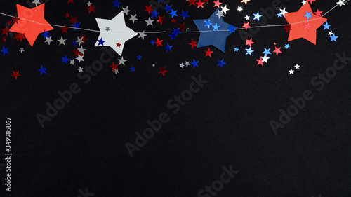 Happy Independence Day banner template, 4th of July celebration concept. Blue red white confetti and stars in USA national colors on black background.